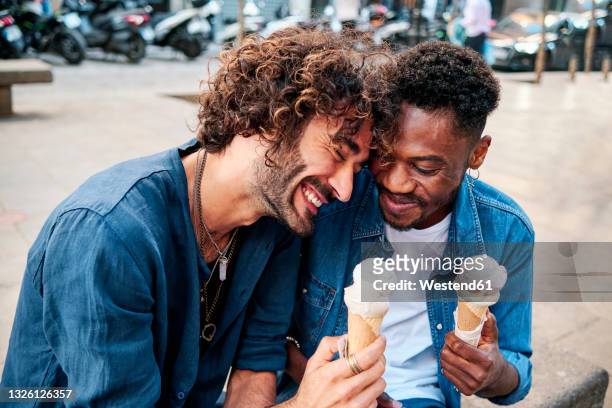 happy gay couple enjoying ice cream - black and white food fotografías e imágenes de stock