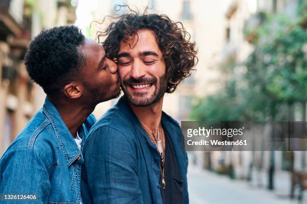 affectionate gay man kissing happy boyfriend - gay man ストックフォトと画像