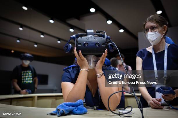 An attendee wears virtual reality goggles on the second day of the 14th edition of the Mobile World Congress at Fira de Barcelona's Gran Via venue on...