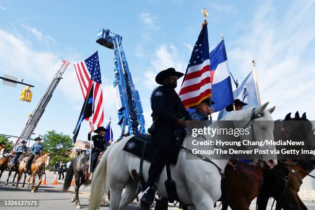 Members of the State Sheriff's Mounted Posse line up for a funeral procession for slain Arvada police Officer Gordon Beesley at Lafayette, Colorado...