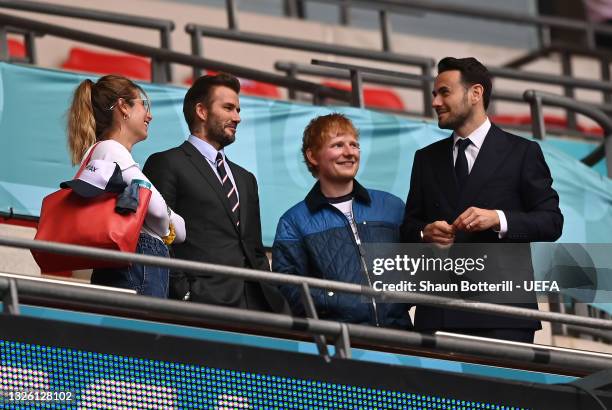 Cherry Seaborn, Wife of Ed Sheeran, David Beckham and Ed Sheeran are seen in the stands with a guest at half time during the UEFA Euro 2020...