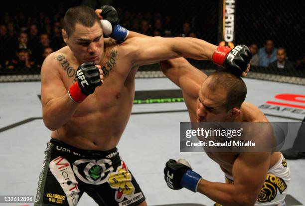 Junior dos Santos lands a punch to send Cain Velasquez down in the first round of their Heavyweight Championship Title bout during the UFC on FOX...