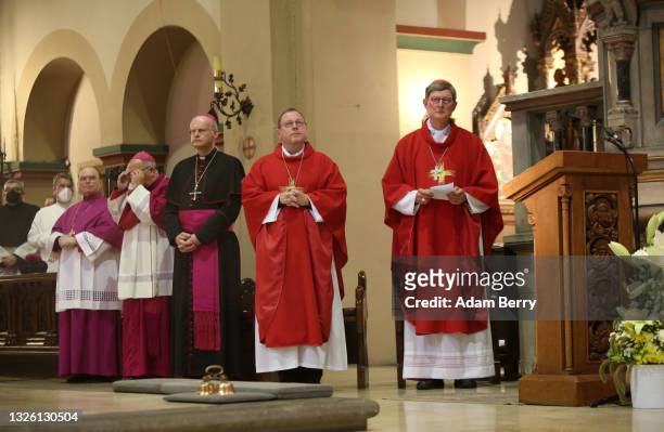 German Cardinal Rainer Maria Woelki listens as Cardinal Secretary of State of the Vatican Pietro Parolin leads an evening Mass service at Saint...