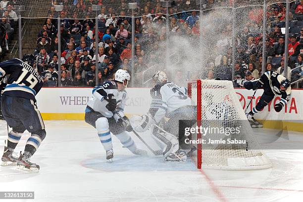 Vinny Prospal looses his footing after passing the puck to Ryan Johansen, both of the Columbus Blue Jackets, as Johansen shoots the puck past Mark...