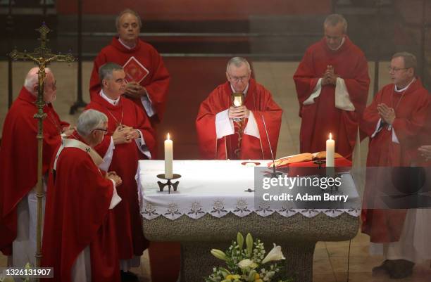 Cardinal Secretary of State of the Vatican Pietro Parolin performs the Eucharist as he leads an evening Mass service at Saint Johannes Basilika on...