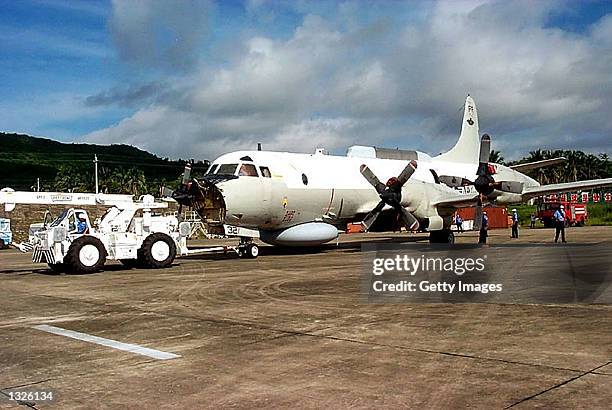 Lockheed Martin Aeronautics Co. Recovery team member repositions the EP-3E "Aries II" aircraft at Lingshui Airfield June 18, 2001 in Hainan, China....