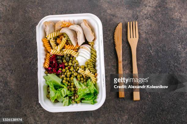 pasta bowl in eco natural paper box. healthy salad with turkey, lettuce, egg, pasta and sause pesto on table. top view - kazakhstan coronavirus stock pictures, royalty-free photos & images