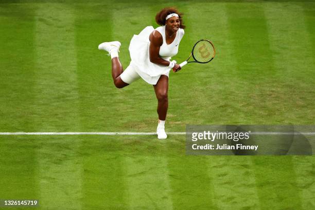 Serena Williams of The United States serves in her Ladies' Singles First Round match against Aliaksandra Sasnovich of Belarus during Day Two of The...