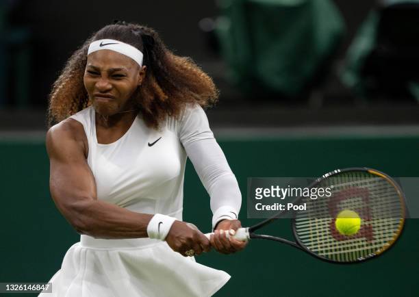 Serena Williams of The United States winces in pain as she plays a backhand in her Ladies' Singles First Round match against Aliaksandra Sasnovich of...