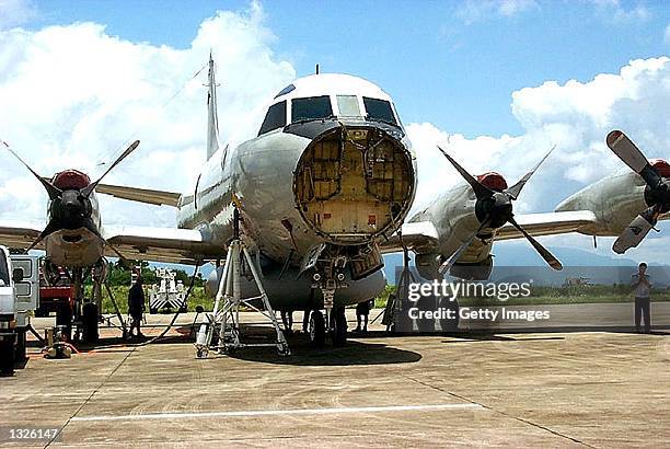 Lockheed Martin Aeronautics Co. Recovery team prepares to drain fuel, oil and hydraulic fluids from the damaged U.S. Navy EP-3E "Aries II"...