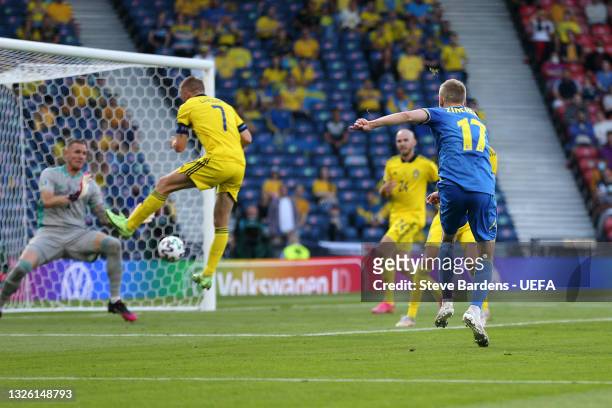 Oleksandr Zinchenko of Ukraine scores their side's first goal past Robin Olsen of Sweden during the UEFA Euro 2020 Championship Round of 16 match...