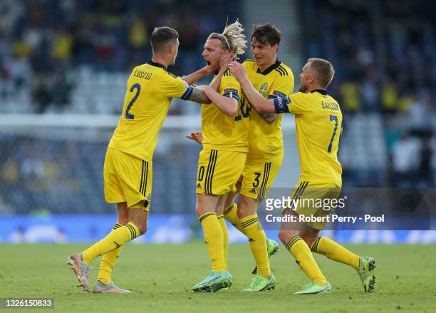 Emil Forsberg of Sweden celebrates with Mikael Lustig, Victor Lindeloef and Sebastian Larsson after scoring their side's first goal during the UEFA...