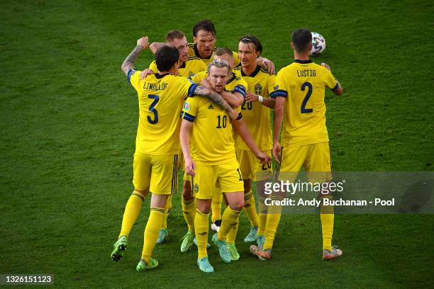 Emil Forsberg of Sweden celebrates with Victor Lindeloef and team mates after scoring their side's first goal during the UEFA Euro 2020 Championship...