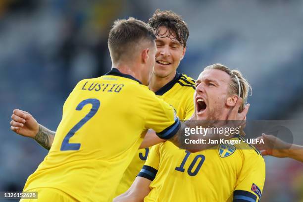 Emil Forsberg of Sweden celebrates with Mikael Lustig and Victor Lindeloef after scoring their side's first goal during the UEFA Euro 2020...