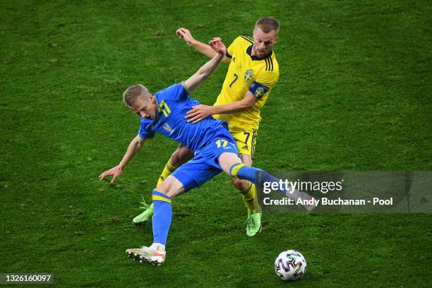 Oleksandr Zinchenko of Ukraine battles for possession with Sebastian Larsson of Sweden during the UEFA Euro 2020 Championship Round of 16 match...