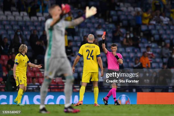 Match Referee, Daniele Orsato shows a red card to Marcus Danielson of Sweden after a VAR review during the UEFA Euro 2020 Championship Round of 16...
