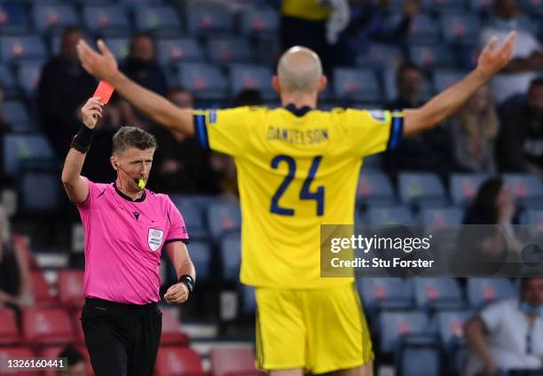 Match Referee, Daniele Orsato shows a red card to Marcus Danielson of Sweden after a VAR review during the UEFA Euro 2020 Championship Round of 16...