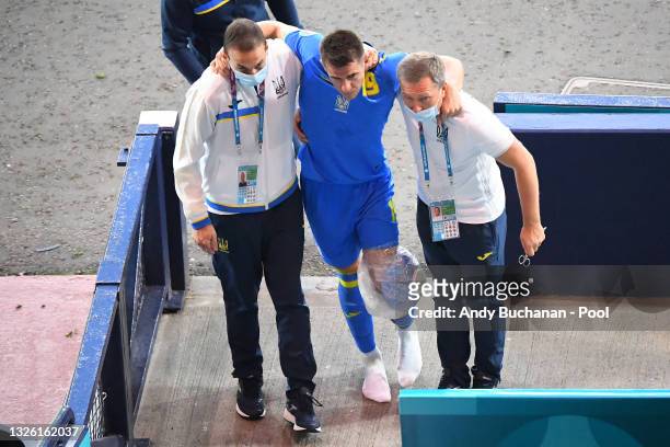 Artem Besedin of Ukraine is seen with an ice pack around his knee following a challenge by Marcus Danielson of Sweden during the UEFA Euro 2020...