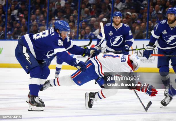 Mikhail Sergachev of the Tampa Bay Lightning checks Brendan Gallagher of the Montreal Canadiens during Game One of the 2021 NHL Stanley Cup Finals...