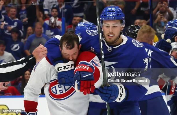 Ross Colton of the Tampa Bay Lightning holds onto Paul Byron of the Montreal Canadiens during Game One of the 2021 NHL Stanley Cup Finals against the...