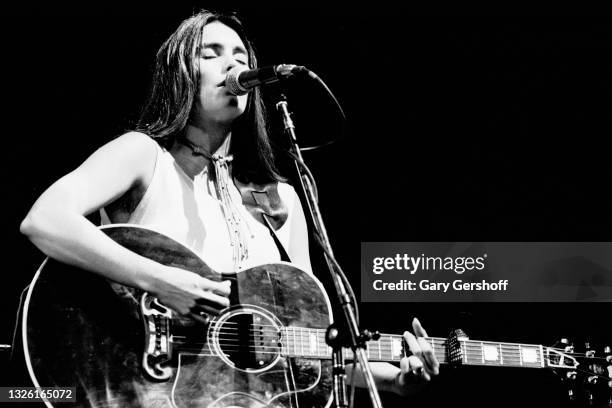 American Country musician Emmylou Harris plays acoustic guitar as she performs onstage during the Dr Pepper Central Park Music Festival, New York,...