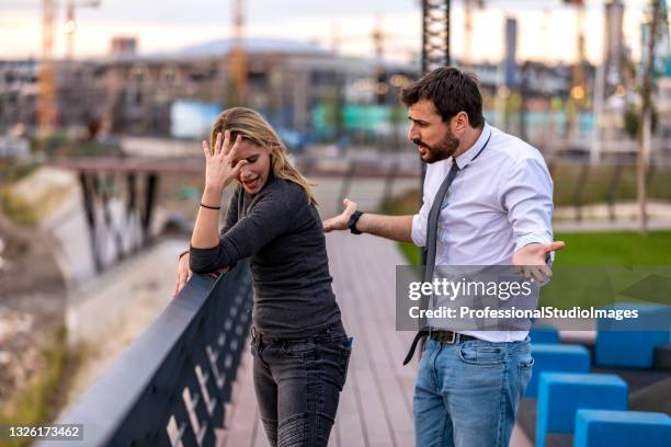 young couple with communication problems is arguing outdoors - annoying colleague stock pictures, royalty-free photos & images