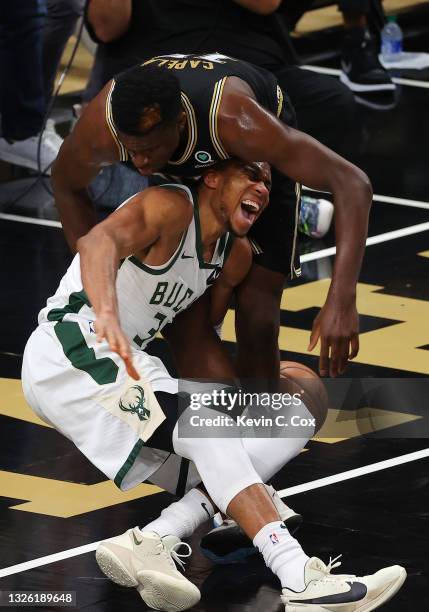 Giannis Antetokounmpo of the Milwaukee Bucks is injured against Clint Capela of the Atlanta Hawks during the second half in Game Four of the Eastern...