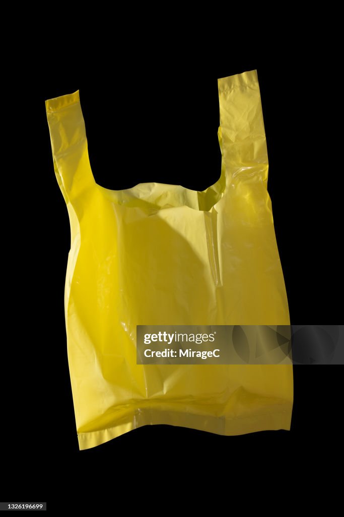 Yellow Colored Plastic Bag on Black