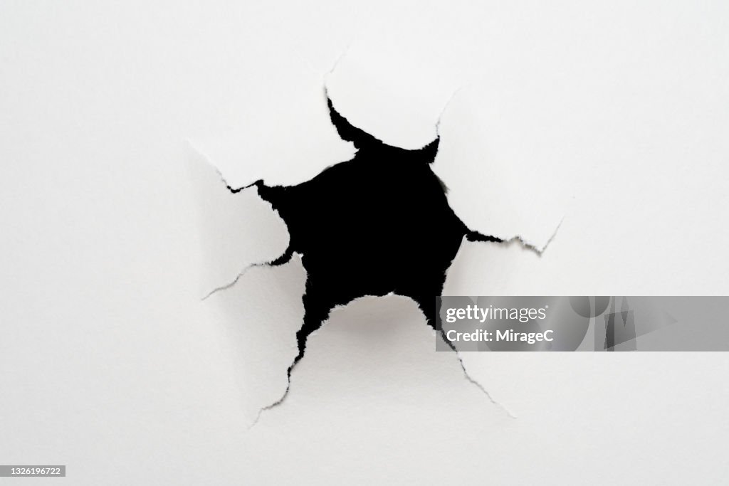 Cracked Paper Hole in Front of Black