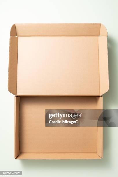 opened empty cardboard box on green - cardboard box top view stock pictures, royalty-free photos & images