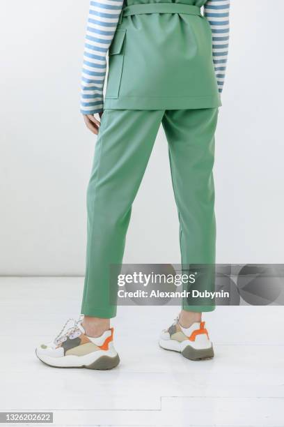 woman model legs in pants and sneakers - sports shoe close up stock pictures, royalty-free photos & images