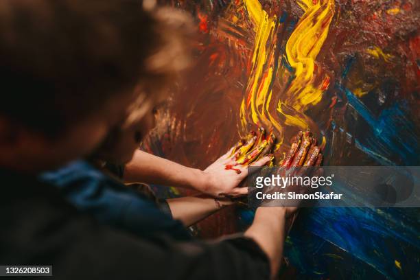 close up of couple hands painting on the canvas - house for an art lover stock pictures, royalty-free photos & images