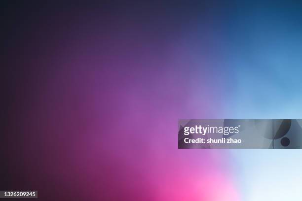 fog illuminated by neon lights at night - purple sky fotografías e imágenes de stock