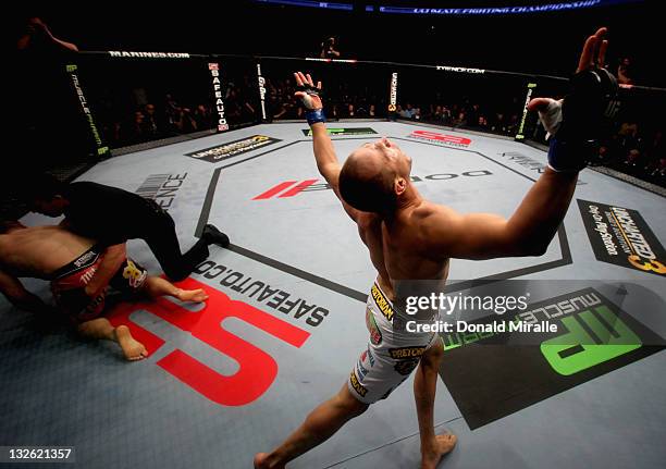 Junior dos Santos celebrates after punching to defeat Cain Velasquez by TKO in the first round of their Heavyweight Championship Title bout during...