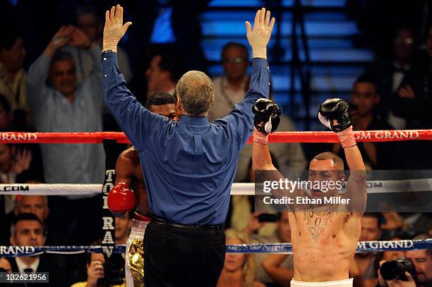 Mike Alvarado celebrates as referee Jay Nady calls the fight as Alvarado wins by a 10th round TKO against Breidis Prescott in their junior...