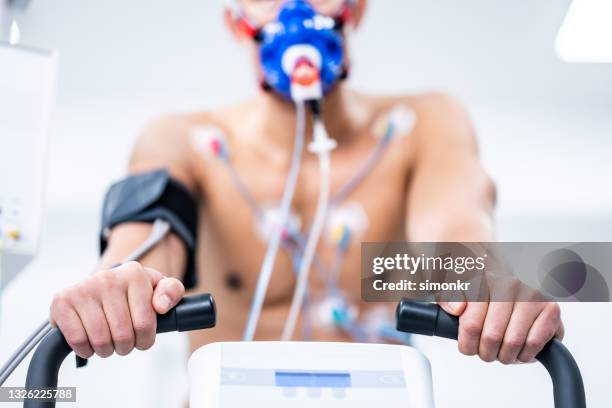 man taking a cardiopulmonary stress test in clinic - stress test stock pictures, royalty-free photos & images