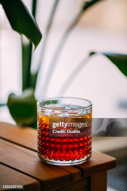 espresso tonic on wooden table - cocktail recipe stock pictures, royalty-free photos & images