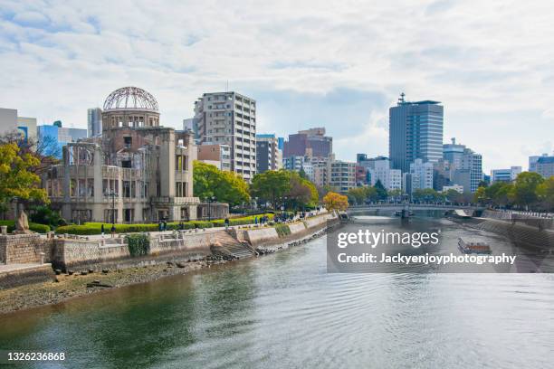 a-bomb (genbaku) dome, hiroshima, japan. the genbaku dome also known as the atomic bomb dome is now a symbol for peace within the hiroshima peace memorial park. - hiroshima peace memorial stock pictures, royalty-free photos & images