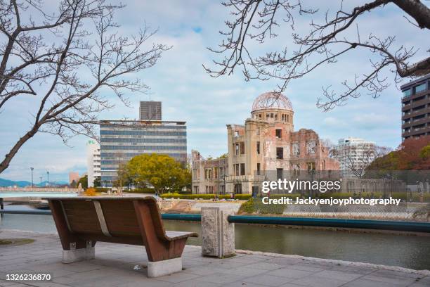 a-bomb (genbaku) dome, hiroshima, japan. the genbaku dome also known as the atomic bomb dome is now a symbol for peace within the hiroshima peace memorial park. - hiroshima peace memorial stock pictures, royalty-free photos & images