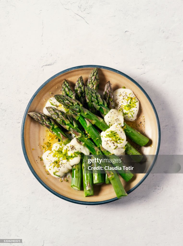Plate of asparagus salad on white background