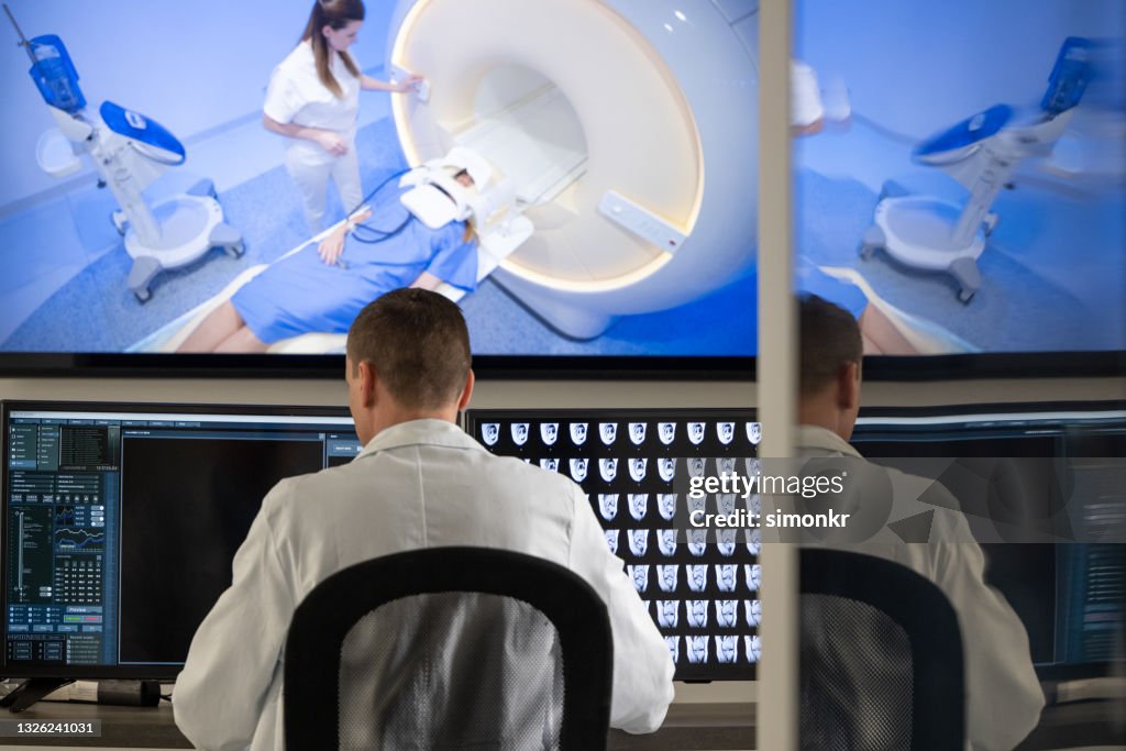 Doctor Radiologist Computer Male Radiologist Looking At The Mri Scans On The Computer High-Res ...