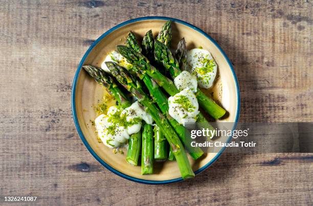 plate of asparagus salad on wooden background - cooked asparagus stock pictures, royalty-free photos & images