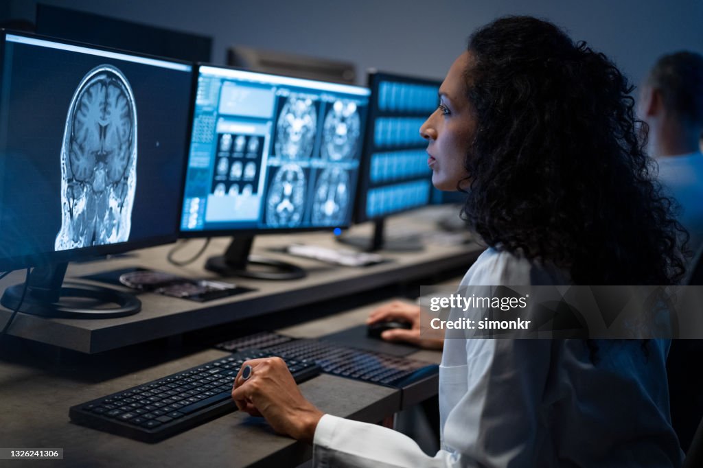 Female radiologist analysing the MRI image of the head