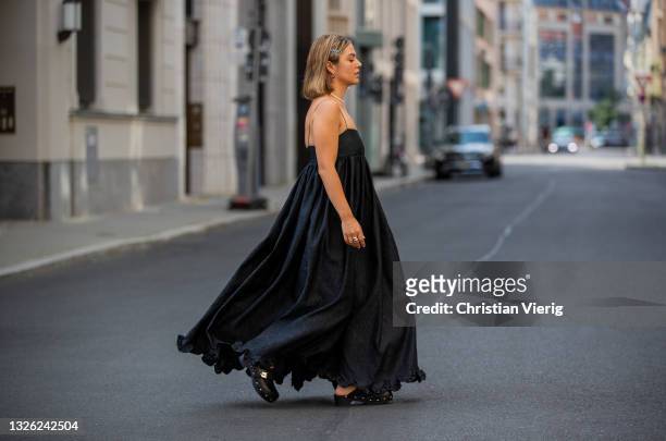 Amelie Stanescu is seen wearing Cecilie Bahnsen dress in black, Prada hair clips, Scholl shoes clogs, noelani jewelry rings and necklace, edbald...