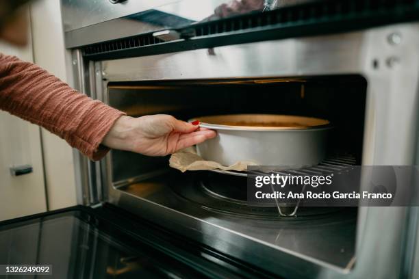 Putting Something In Putting Something In The Oven Photos and Premium High Res Pictures ...