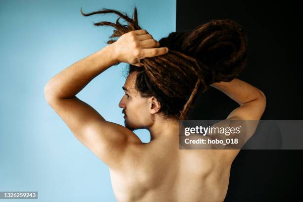 back view of handsome shirtless young man holding his long hair - dreadlocks back stock pictures, royalty-free photos & images