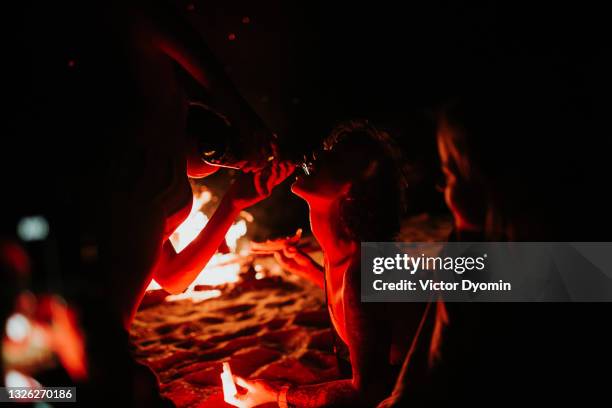 girl drinks champagne on the night beach - full body bildbanksfoton och bilder