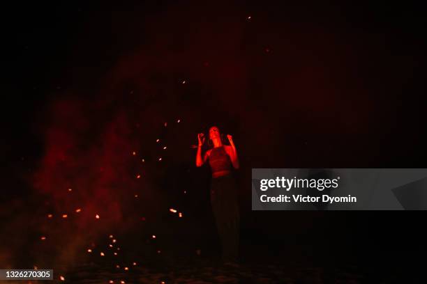 young woman on the beach at night - bonfire beach stock pictures, royalty-free photos & images