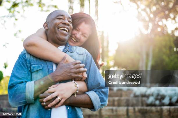 middle aged couple smiling - sun flare couple stock pictures, royalty-free photos & images