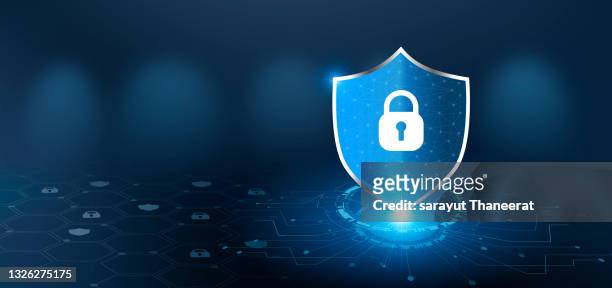 shield with key inside on blue background the concept of cybersecurity the internet - protegerse con las manos fotografías e imágenes de stock
